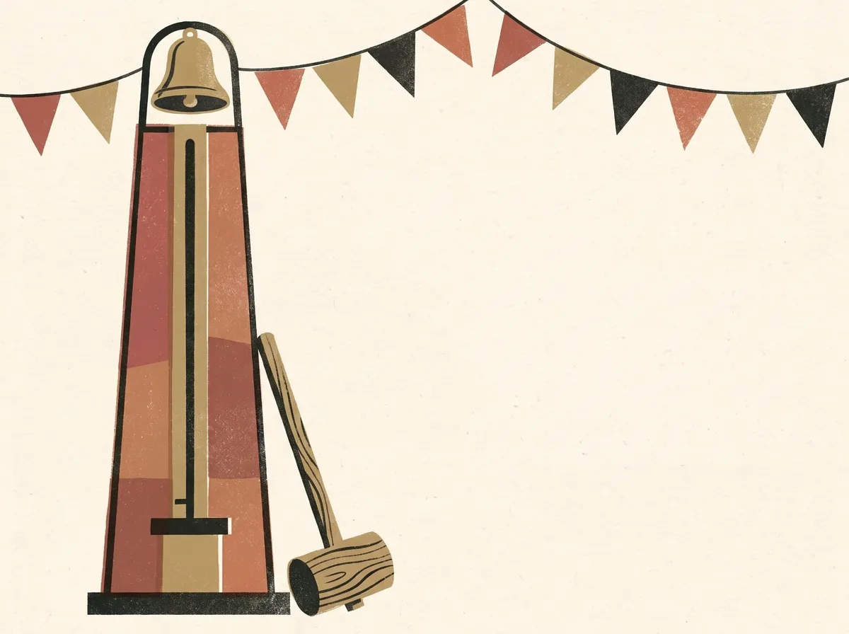 A fairground strength-test tower with a bell at the top, a wooden mallet leaning against it and bunting strung overhead.