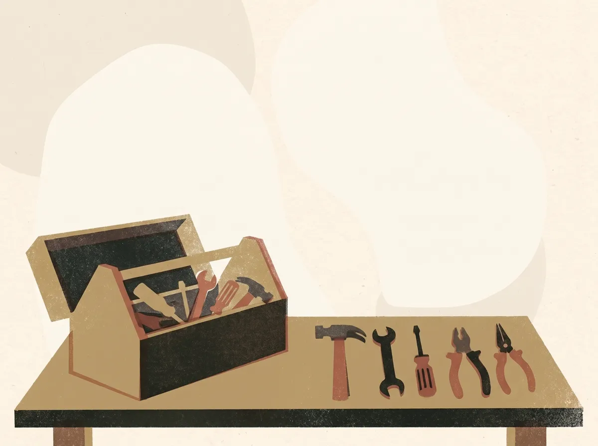 An open wooden toolbox on a workbench, with a hammer, a spanner, a screwdriver and two pairs of pliers laid out in a row.